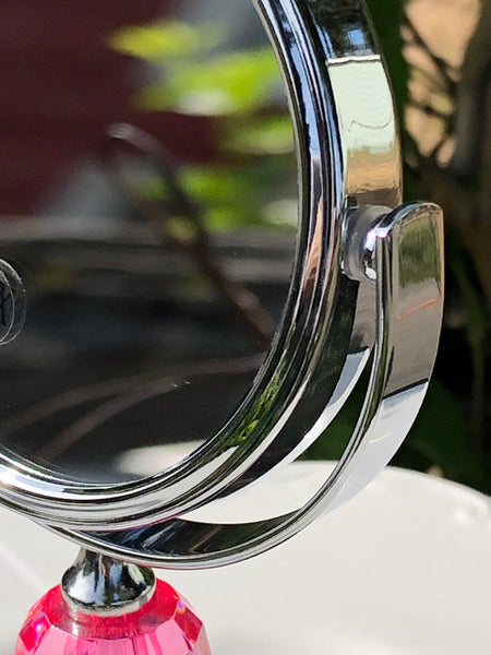 Close-up of a shiny metallic mirrow on a white background