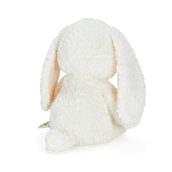 Back view of white plush bunny on a white background