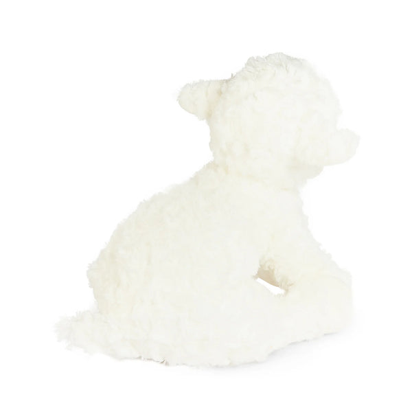 Back view fluffy white plush lamb toy sitting on a seamless white background.
