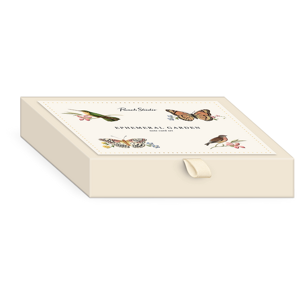 Decorative note card box with bird, butterfly and flower designs on a cream background 