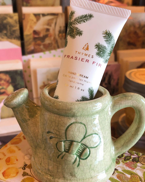 Thymes Frasier Fir Petite Hand Cream Shown in Tiny Green Pottery Watering Can