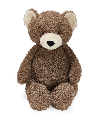 A brown teddy bear plush toy with a textured, curly bouclé-like fur and a cream-colored snout and inner ears, sitting against a plain white background.
