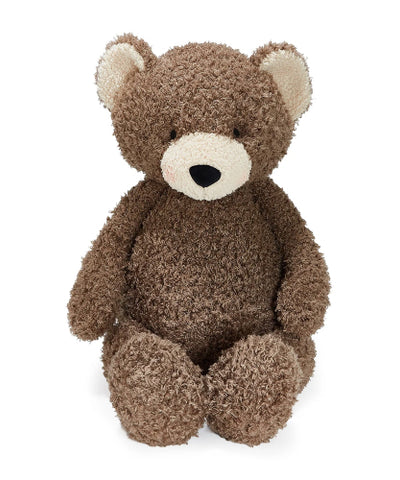 A brown teddy bear plush toy with a textured, curly bouclé-like fur and a cream-colored snout and inner ears, sitting against a plain white background.