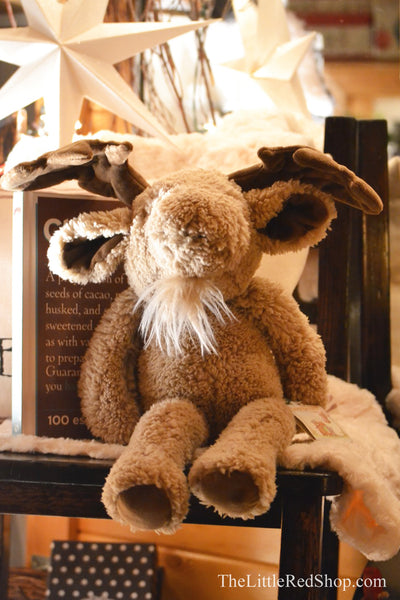 Bunnies by the Bay Bruce the Moose sitting in a chair in The Little Red Shop
