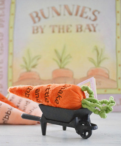 Carrot Rattle with a wheelbarrow and 'Bunnies by the Bay' sign in the background