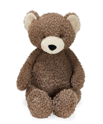 A brown curly-textured plush teddy bear with cream-colored inner ears and snout, sitting against a solid white background.