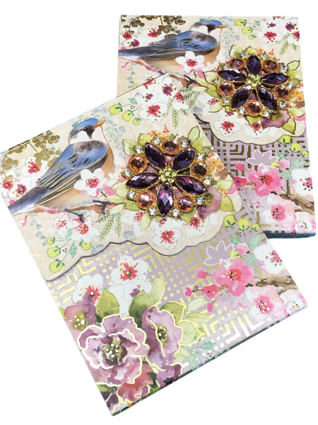 Decorative notepads with floral and bird designs