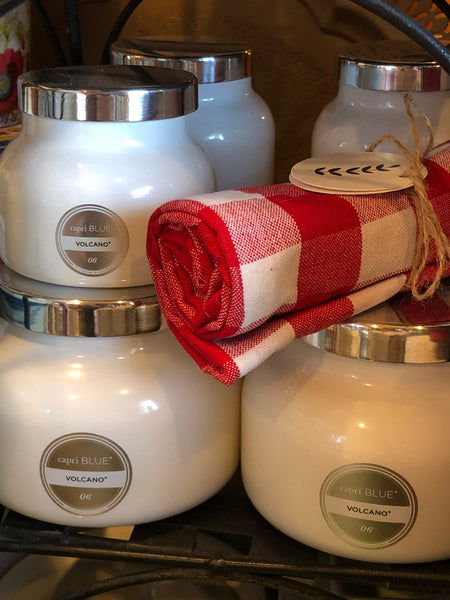 Capri Blue Volcano Statement Candles in Display with Red & White Checkered Dish Towel
