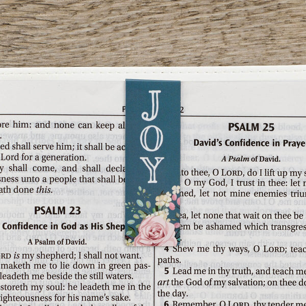 Bookmark with floral design and 'JOY' text on a Bible page