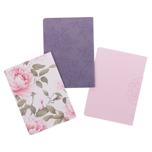 Three floral notebooks in pink, purple, and white on a white background