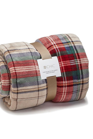 Roll-up plaid blanket with a visible brand label on a white background