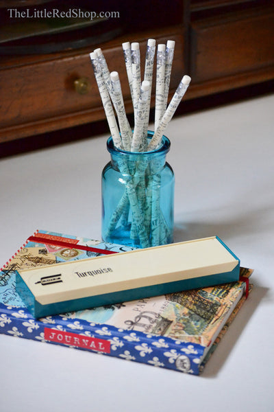 Vintage aqua pencil case and turquoise Belgian apothecary jar with a Paris journal