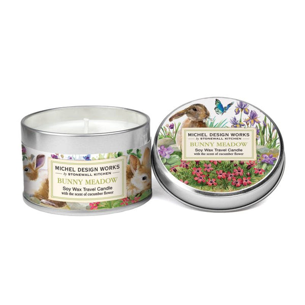 Close up  Michel Design Works Bunny Meadow Soy Wax Travel Tin Candle w/ Rabbits, Spring Flowers and a butterfly