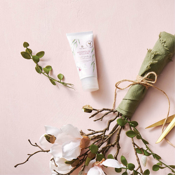Thymes Magnolia Willow Hand Cream Displayed with Magnolia Flowers